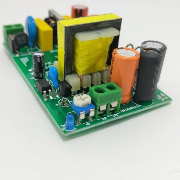 SMPS PCB board side angle view showing transformer, capacitors and output terminal block