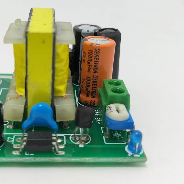SMPS PCB output section close up showing output capacitor terminal block and voltage adjustment circuit